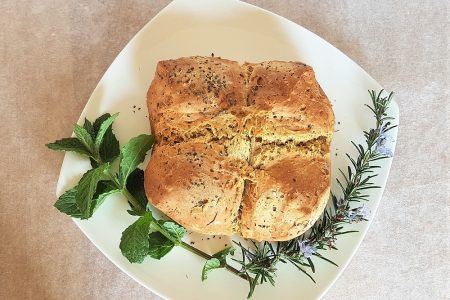 Finished soda bread decorated with mint and rosemary.