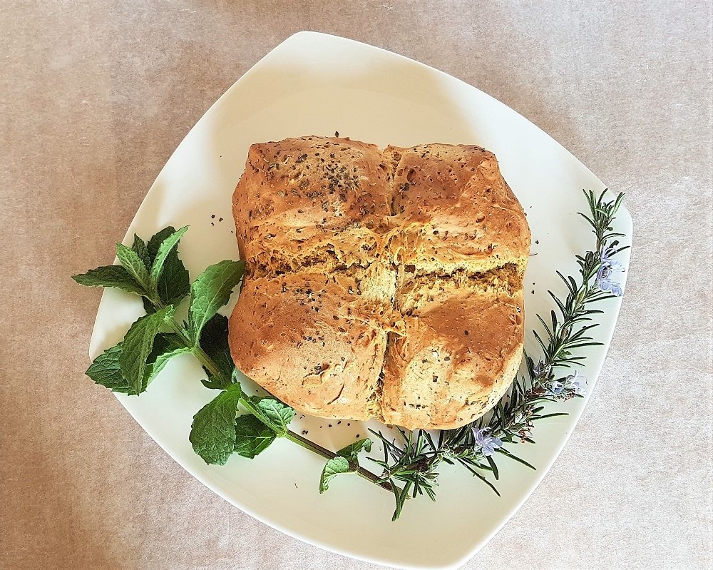 Finished soda bread decorated with mint and rosemary.