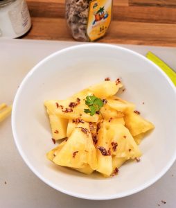 A bowl of freshly cut pin apple with garnishing