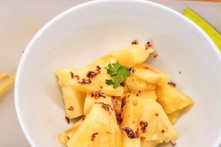A bowl of freshly cut pin apple with garnishing