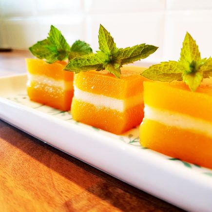 Golden orange coloured butternut squash kuih in a row.