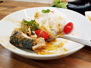 Fish curry on a plate with rice.