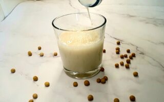 Soy milk being poured into a glass.