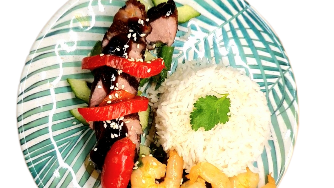 Duck breasts served with vegetable stir fry and rice.