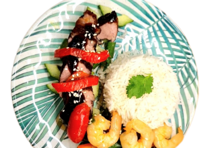 Duck breasts served with vegetable stir fry and rice.