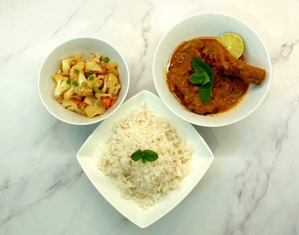 Curry Kapitan served with rice and vegetables