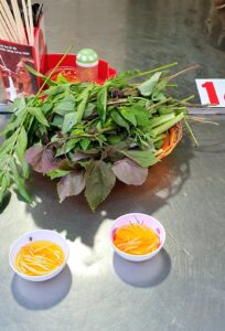 A big plate of fresh herbs and vegetables to go with th food